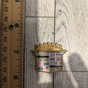 cadillac Gold and Silver Car Emblem with Multicolor Accents